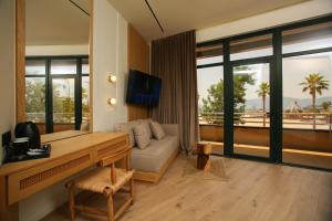 a living room with a desk and a couch with a view at Hotel Brooklyn Vlore in Vlorë