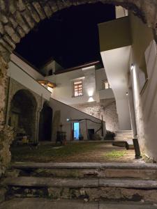 an archway leading to a building at night at N'haidea - AgriFarm e B&B in Lettere