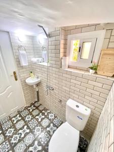 a bathroom with a white toilet and a sink at Dar Chemous -1- دار شموس in Tangier +30 photos
