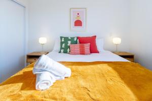 a bedroom with a bed with towels on it at Elegant Living by Middleton Park, Fully Equipped in Christchurch +19 photos