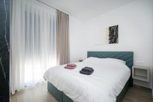 a bedroom with a bed with two towels on it at Family friendly house with a swimming pool Bibinje, Zadar - 23364 in Bibinje +18 photos