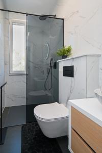 a bathroom with a toilet and a glass shower at Family friendly house with a swimming pool Bibinje, Zadar - 23364 in Bibinje