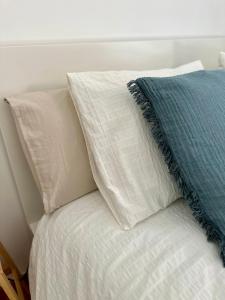 a pile of pillows sitting on a bed at Apartamento Estrellas de Mar in Ribeira +18 photos