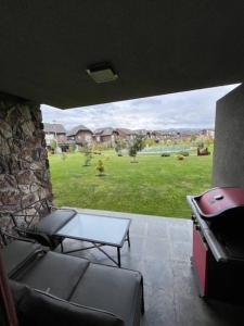 a view of a patio with a table and a grill at Departamento Costa Pucón in Pucón