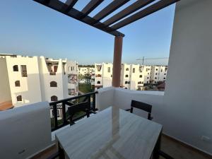 a balcony with a table and some white buildings at Luxury Apartment in Cabo in Cabo Negro