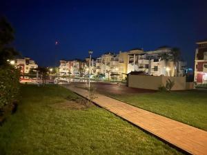 a walkway in front of some buildings at night at Appartement MARINA AP4 SAIDIA in Saïdia