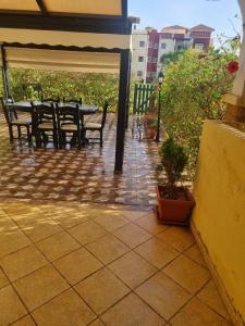 a patio with a table and chairs and flowers at Appartement MARINA AP4 SAIDIA in Saïdia +3 photos