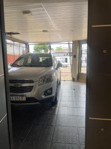a car parked in a garage with a car parked at Oga Guasu casa con piscina exclusiva in Puerto Iguazú