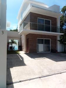 a house with a large driveway in front of it at Ocean Bliss in Sosúa