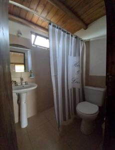a bathroom with a toilet and a sink at El Descanso en San Rafael in San Rafael