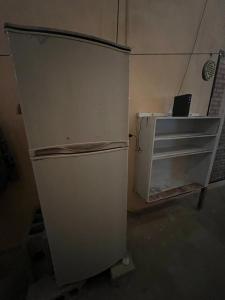 a white refrigerator in a room with a table at やどバンブー in Hateruma