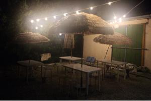 a group of tables and umbrellas in a dark room at やどバンブー in Hateruma