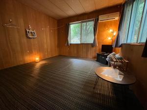 an empty living room with a table and a window at やどバンブー in Hateruma