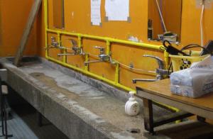 a bathroom with two sinks and faucets on a wall at やどバンブー in Hateruma