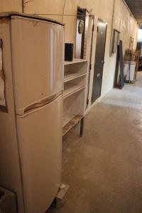 a kitchen with a refrigerator in a room at やどバンブー in Hateruma