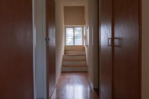 a hallway with stairs and a window in a house at 20C Ryukyu in Nakijin