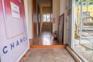 a hallway of a building with a door open at 20C Ryukyu in Nakijin