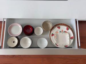 a shelf with bowls and plates on it at 20C Ryukyu in Nakijin
