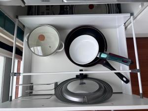 a pot and a frying pan and a mirror on a shelf at 20C Ryukyu in Nakijin
