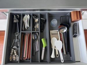 a drawer filled with utensils in a kitchen at 20C Ryukyu in Nakijin