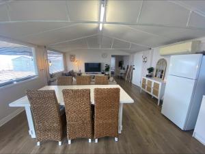 a kitchen and living room with a table and chairs at 21 - Black Point in Pine Point