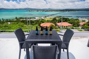 a table with bottles of wine on top of a balcony at 20C Ryukyu in Nakijin