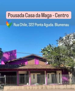 a building with a fence in front of it at Maga Inn House - Centro in Blumenau