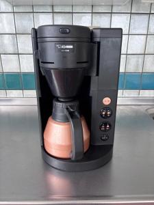 a coffee maker sitting on top of a counter at 20C Ryukyu in Nakijin
