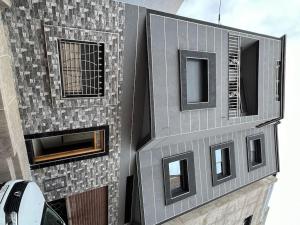 a tall building with windows on the side of it at Spacious apartment for a comfortable stay in Al Hoceïma