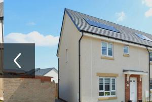 a house with a solar panel on top of it at Edinburgh upper villa end terrace in Edinburgh
