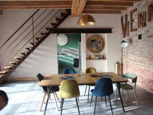 a dining room with a wooden table and chairs at Gîte de charme avec spa, piscine intérieure et jardin clos près de Chinon - FR-1-381-553 in Beaumont-en-Véron