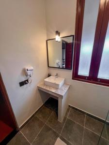 a bathroom with a sink and a mirror at Ecosfera Hotel & Spa in Canggu