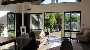 a living room with a couch and some windows at Villa Rochford in Kellevie