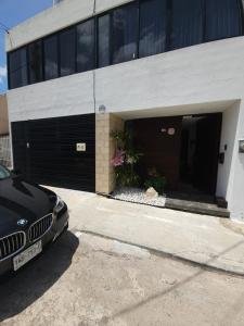 a black car parked in front of a building at Villa Alejandra Merida Yucatan in Mérida