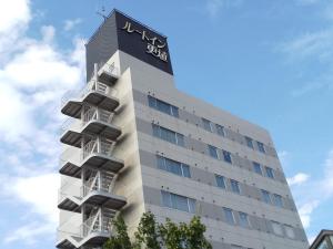 a building with a sign on the side of it at Hotel Route-Inn Court Chikuma-Koshoku in Chikuma