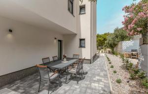 a patio with a black table and chairs at Awesome Home In Veliko Brdo With Wifi in Veliko Brdo