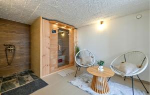 a room with two chairs and a table and a shower at Cozy Home In Vrtlinovec With Sauna in Vrtlinovec