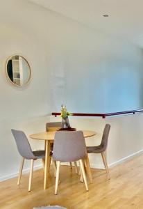 a dining room table and chairs with a vase on it at Ascot Vale - Lovely 2 bedroom townhouse close to everything! in Ascot Vale