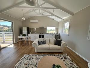 a living room with a couch and a kitchen at Las Casitas in Donnybrook