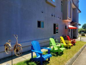 a group of colorful chairs sitting outside of a building at V.I.P. CLUB in Surrey
