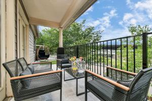 a patio with chairs and a table on a balcony at ProlificSuites Escape - Stylish Spaces & Prime Location in Houston