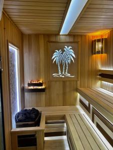 a room with a sauna with palm trees on the wall at Harris Hotel Spa&Fitness in Tashkent