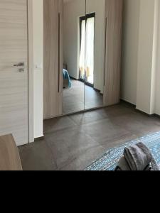 a room with a mirror and a room with a bed at Tenuta Grezzosa in Vibonati