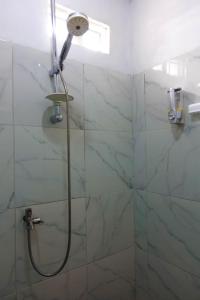 a shower with a shower head in a bathroom at Angel homestay and shop in Dompu +17 photos