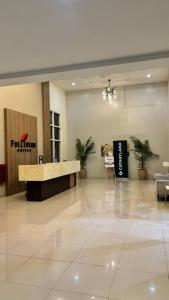 a lobby with a desk in the middle of a building at Cozy Studio Condo Unit at Fullerton Suites in Silang