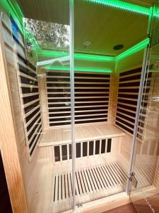 a front door of a room with green lights at Gorgeous 3 bedroom raked ceiling cabin on the hill in Blackbutt
