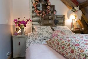 a bedroom with a bed with flowers on it at La petite maison dans la campagne in Massingy-lès-Vitteaux