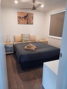 a bedroom with a bed with a pillow on the floor at Moree Tourist Park in Moree