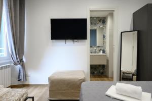 a living room with a flat screen tv on a wall at Rhoome Holiday 1 in Rome