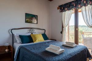 a bedroom with a bed with two towels on it at House Demetra in Astris